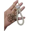 A golden diamond-encrusted flower-shaped keychain with a beige woven leather rope handle ring Item Picture
